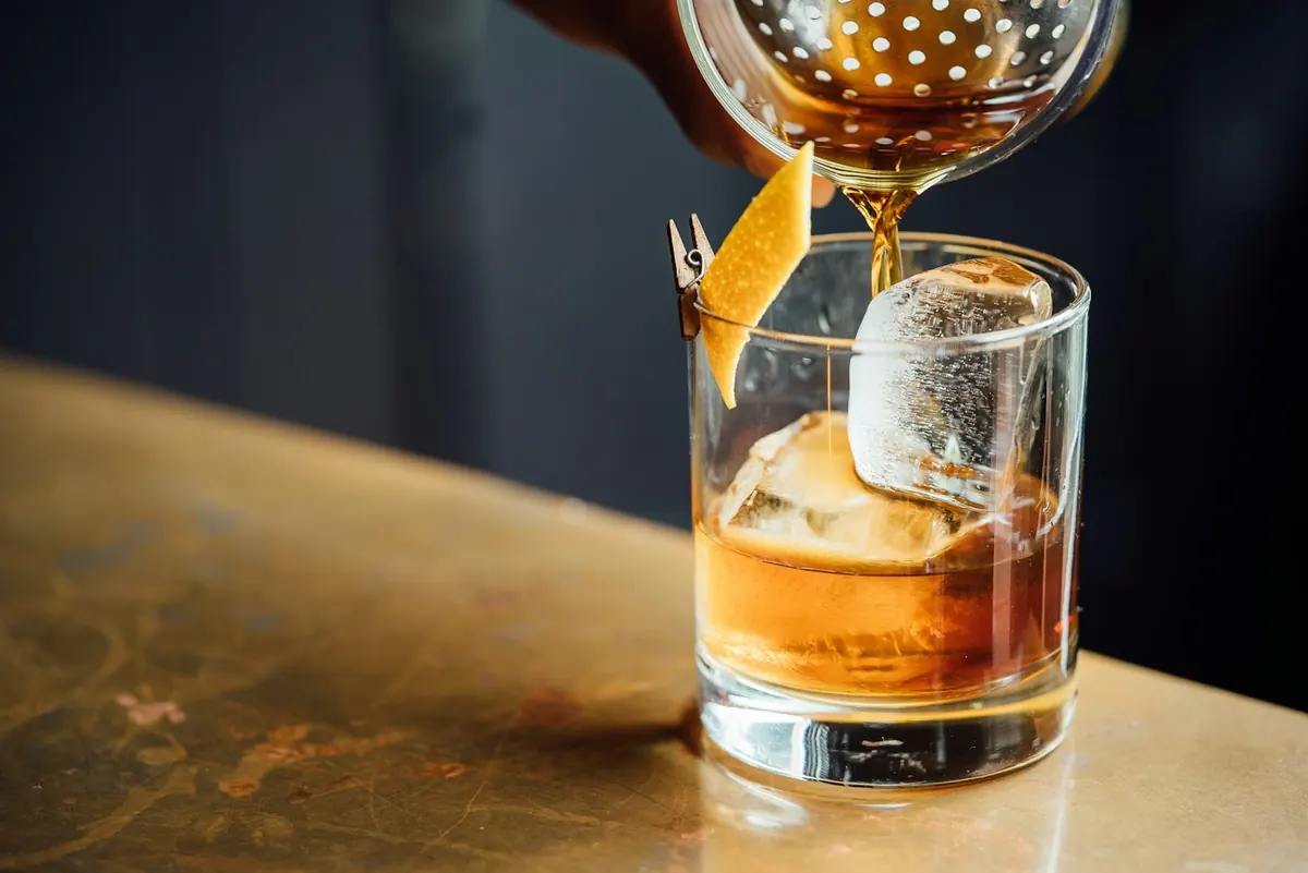 Whisky poured over ice at the bar